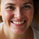 Emma, satisfied client showing successful postnatal recovery